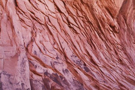 Texture of mountains of red color. Stone rough rough volumetric background, layering. Natural creation, majestic stone wall. The structure and geology of the American mountains. Layout for design.の写真素材