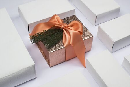 Christmas and New Year's gifts in the form of a square on white background. Gift box bronze color...