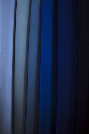 Bright blue collection textile cloth samples in store. Trend color 2020 classic blue, layout for...