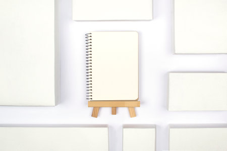 White cardboard boxes with notepad on a white background, concept of shopping and delivery. Many...