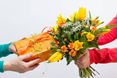 Handing out a present and a bouquetの写真素材