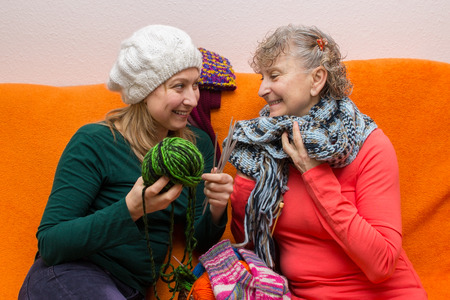 Mother and daughter knitting togetherの写真素材
