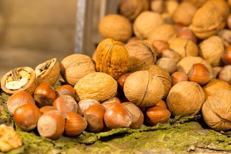 Closeup of various nuts on a piece of wood