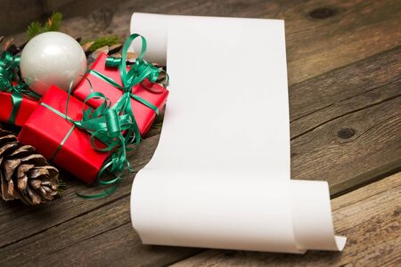 A list of Christmas wishes next to several small giftsの写真素材
