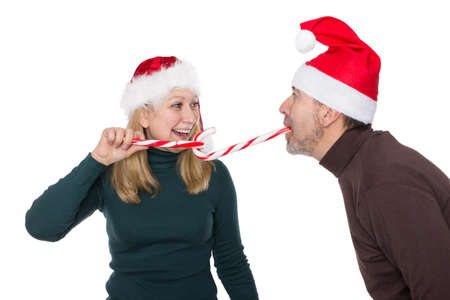 A man and a woman have fun with a candy caneの写真素材