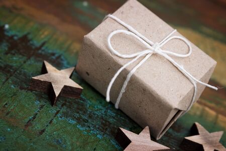 Closeup of a simple gift on a colorful wooden tableの写真素材