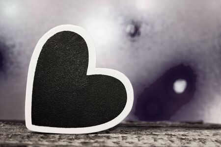 A black heart with white border photographed in black and whiteの写真素材