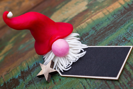 Elf with red hat and a black label
