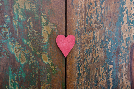 A red heart on a colorful wooden backgroundの写真素材