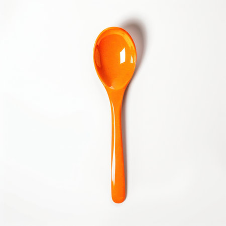 an orange spoon isolated on a white backgroundの写真素材