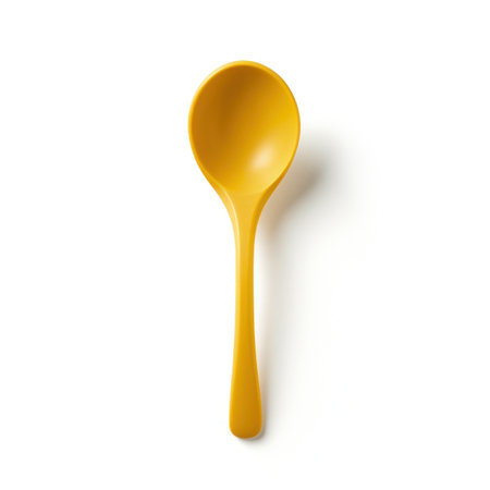 a yellow spoon isolated on a white backgroundの写真素材