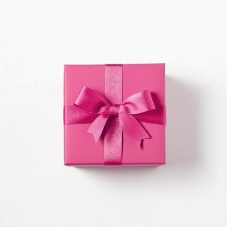 Pink gift box with a bow on a white background, top viewの写真素材