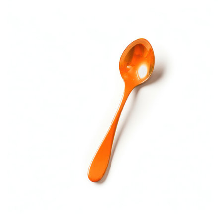 Orange plastic spoon isolated on white background.の写真素材
