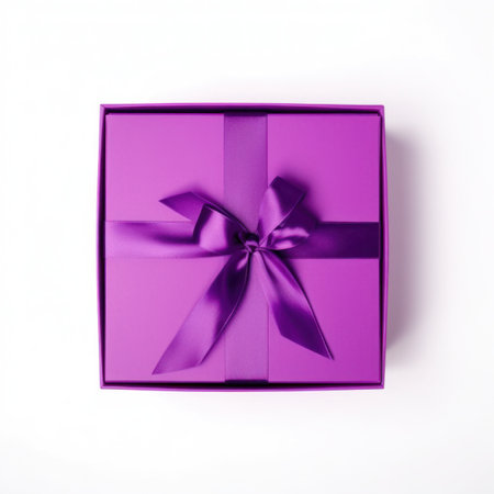 Purple gift box with ribbon isolated on white background. Top view.の写真素材