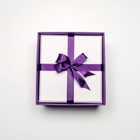 Gift box with purple ribbon on white background. Top view.の写真素材