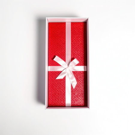 Open red gift box with white bow on white background. Top view.の写真素材