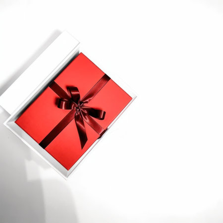 Red gift box with a red ribbon on a white background. Top view.の写真素材