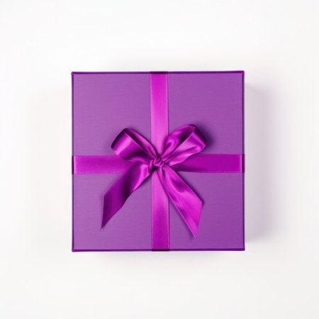 Purple gift box with bow on white background. Top view.の写真素材
