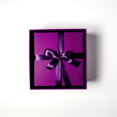 Purple gift box with a bow on a white background, top viewの写真素材