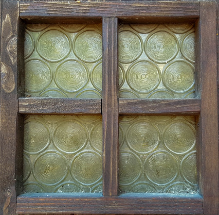 Old windows with yellow glassesの写真素材