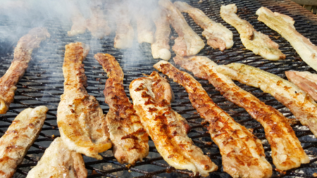 crispy bacon cooked on bbqの写真素材