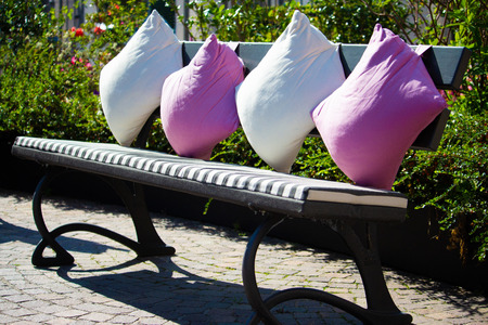 bench with comfortable cushions in a park 2