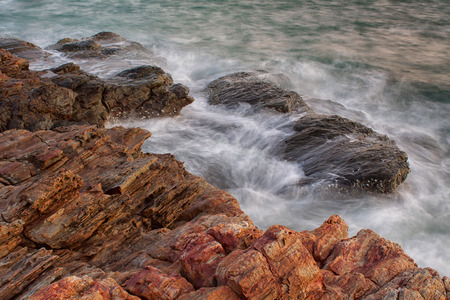 Ocean waves crashing onto the rocksの写真素材