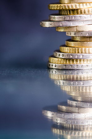 Euro money.Coins are isolated on a dark background with reflection in a glass. Currency of Europe. Balance of money. Building from coins.の写真素材