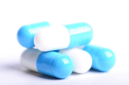 Tablets. Pills on a white background. Isolated. Building from pills. Pharmacy. Medical background. Medicine. Capsule on a spoon. close upの写真素材