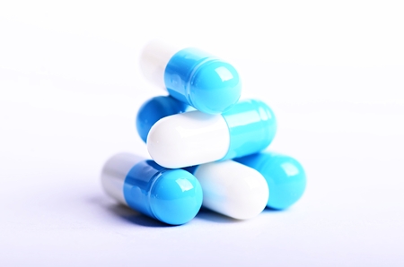 Tablets. Pills on a white background. Isolated. Building from pills. Pharmacy. Medical background. Medicine. Capsule on a spoon. close upの写真素材