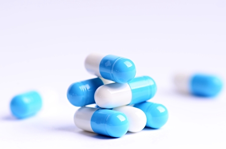 Tablets. Pills on a white background. Isolated. Building from pills. Pharmacy. Medical background. Medicine. Capsule on a spoon. close upの写真素材