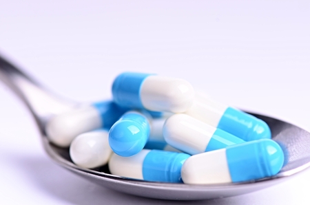 Tablets. Pills on a white background. Isolated. Building from pills. Pharmacy. Medical background. Medicine. Capsule on a spoon. close upの写真素材