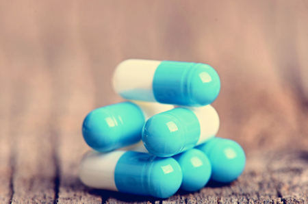 Pharmacy background. Pills on a wooden table. Medicine. Natural background. Capsule. close upの写真素材