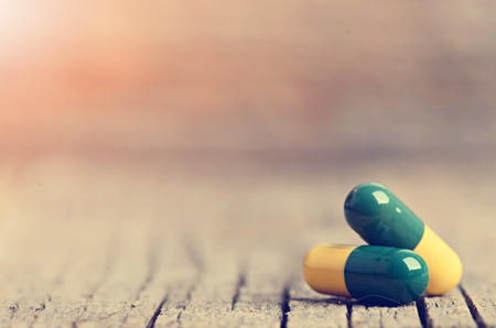 Pharmacy background. Pills on a wooden table. Medicine. Natural background. Capsule. close upの写真素材