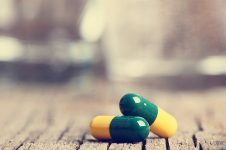 Pharmacy background. Pills on a wooden table. Medicine. Natural background. Capsule. close upの写真素材