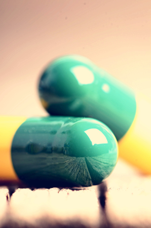 Pharmacy background. Pills on a wooden table. Medicine. Natural background. Capsule. close upの写真素材