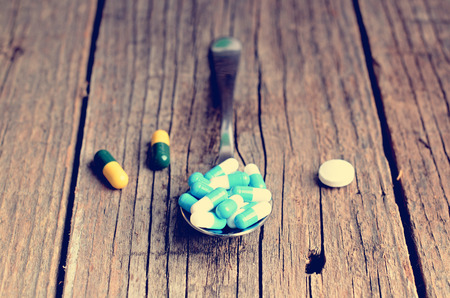 Pharmacy background. Pills on a wooden table. Medicine. Natural background. Capsule. close upの写真素材