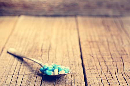 Pharmacy background. Pills on a wooden table. Medicine. Natural background. Capsule. close upの写真素材