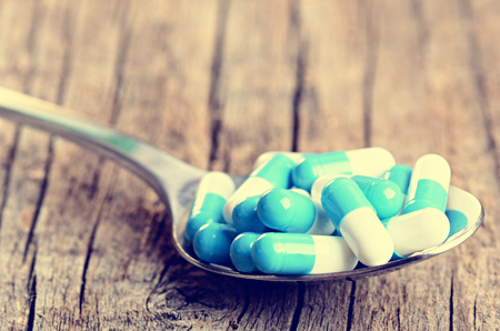 Pharmacy background. Pills on a wooden table. Medicine. Natural background. Capsule. close upの写真素材