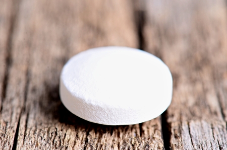 Pharmacy background. Pills on a wooden table. Medicine. Natural background. Capsule. close upの写真素材