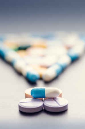 Pharmacy background on a black table.Exclamation. Punctuation mark. Tablets on a black background. Pills. Medicine and Health. Close up of capsules. Differend kind of pillsの写真素材