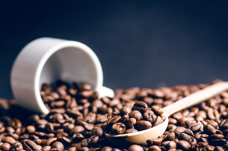 Spoon of coffee beans. Background. Energy. Raw coffee beans. Grained product. Hot drink. Close up. Harvesting. Natural background. Lifestyle. Coffee break in a morning. Wooden spoon. Steamの写真素材