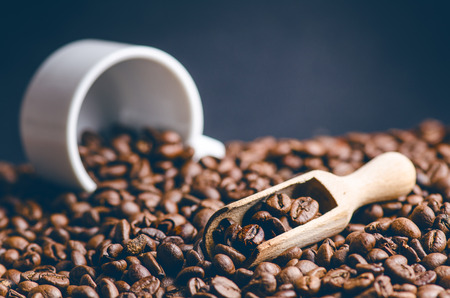 Spoon of coffee beans. Background. Energy. Raw coffee beans. Grained product. Hot drink. Close up. Harvesting. Natural background. Lifestyle. Coffee break in a morning. Wooden spoon. Steamの写真素材