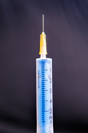 Medical injection on dark background. Medicine plastic vaccination equipment with needle. Health and care. Vaccination. Medicine background. Studio isolated. Phobiaの写真素材