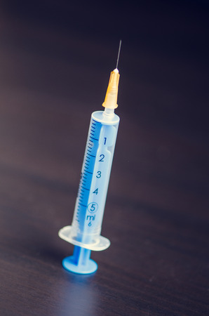 Medical injection on dark background. Medicine plastic vaccination equipment with needle. Health and care. Vaccination. Medicine background. Studio isolated. Phobiaの写真素材