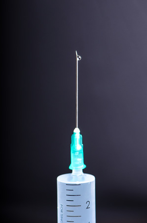 Medical injection on dark background. Medicine plastic vaccination equipment with needle. Health and care. Vaccination. Medicine background. Studio isolated. Phobiaの写真素材