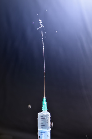Medical injection on dark background. Medicine plastic vaccination equipment with needle. Health and care. Vaccination. Medicine background. Studio isolated. Phobiaの写真素材