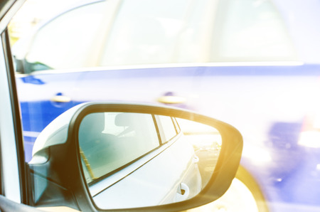 Concept of speed. Car driving on the road. Reflection in a car mirror.Rear view mirror reflection. Blurry background.の写真素材