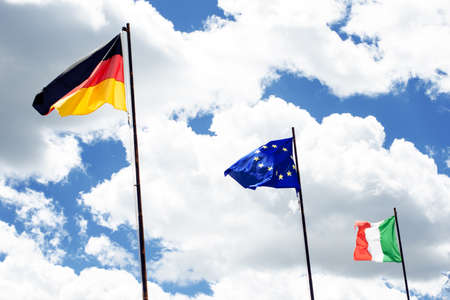 Flags of europe, germany and italy. Sky and clouds like a background. Waving flags. borderの写真素材