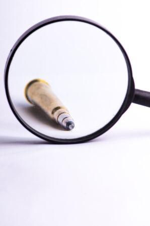 Ammunition on a white background. View through a magnifier. Isolated. Close up. Weapons. Bulletsの写真素材